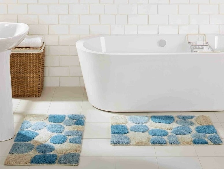 the set of two bath rugs with a pebble pattern in a bathroom