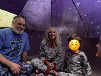 reviewers smiling inside of their air fort