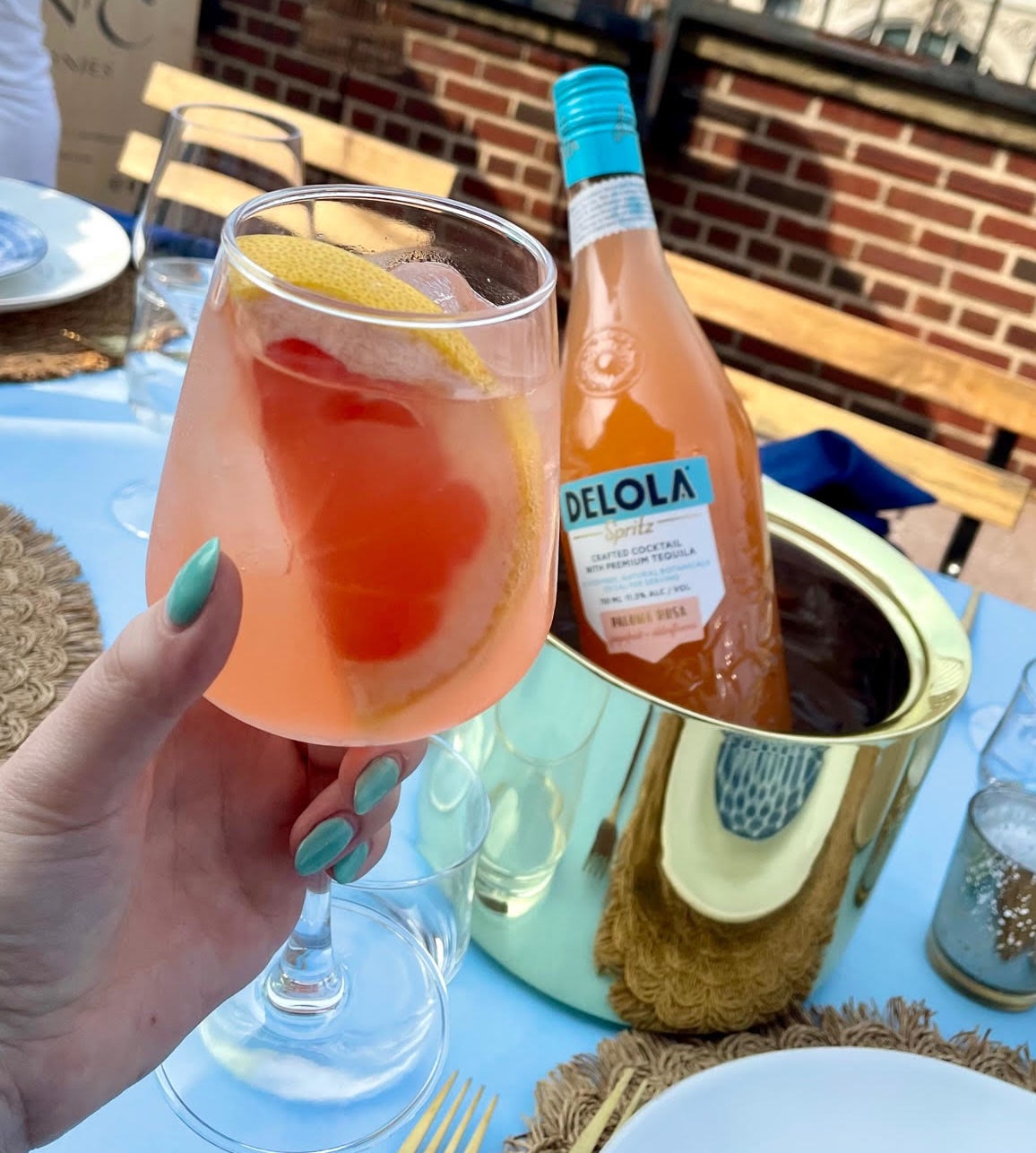 author holding a glass of the spritz