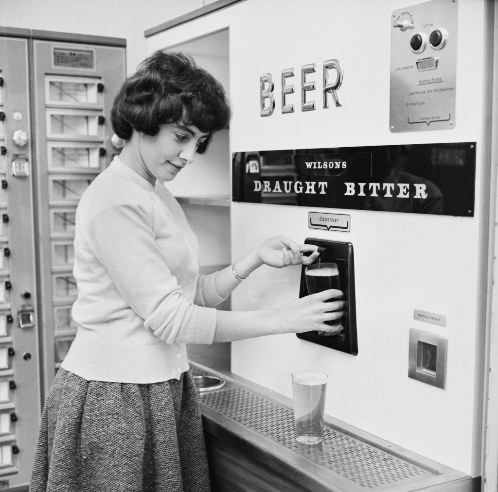 A woman using a beer vending machine