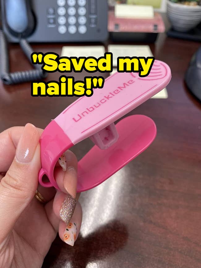 A reviewer holding a pink the the tool