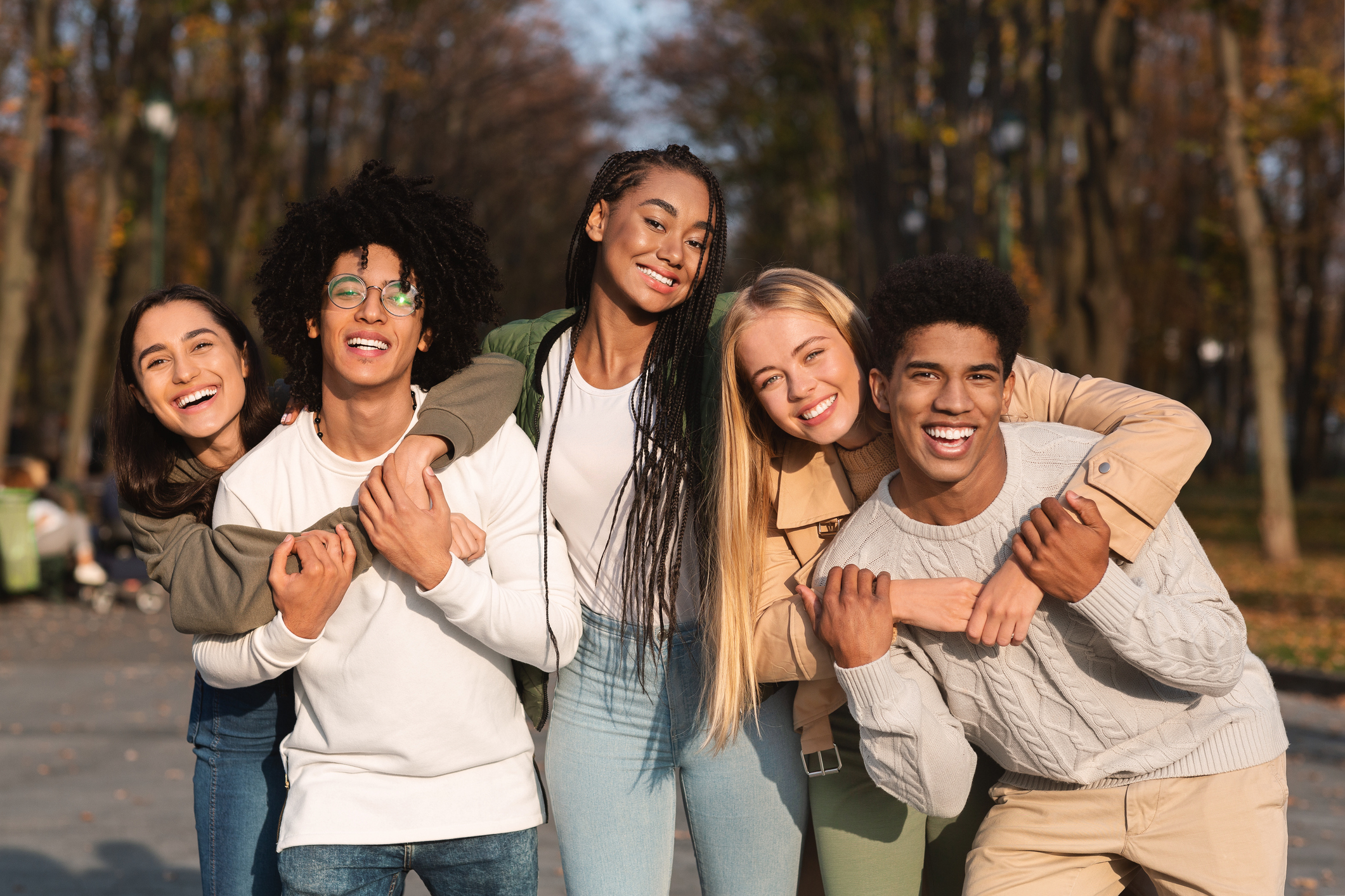 A group of young people smiling and hugging