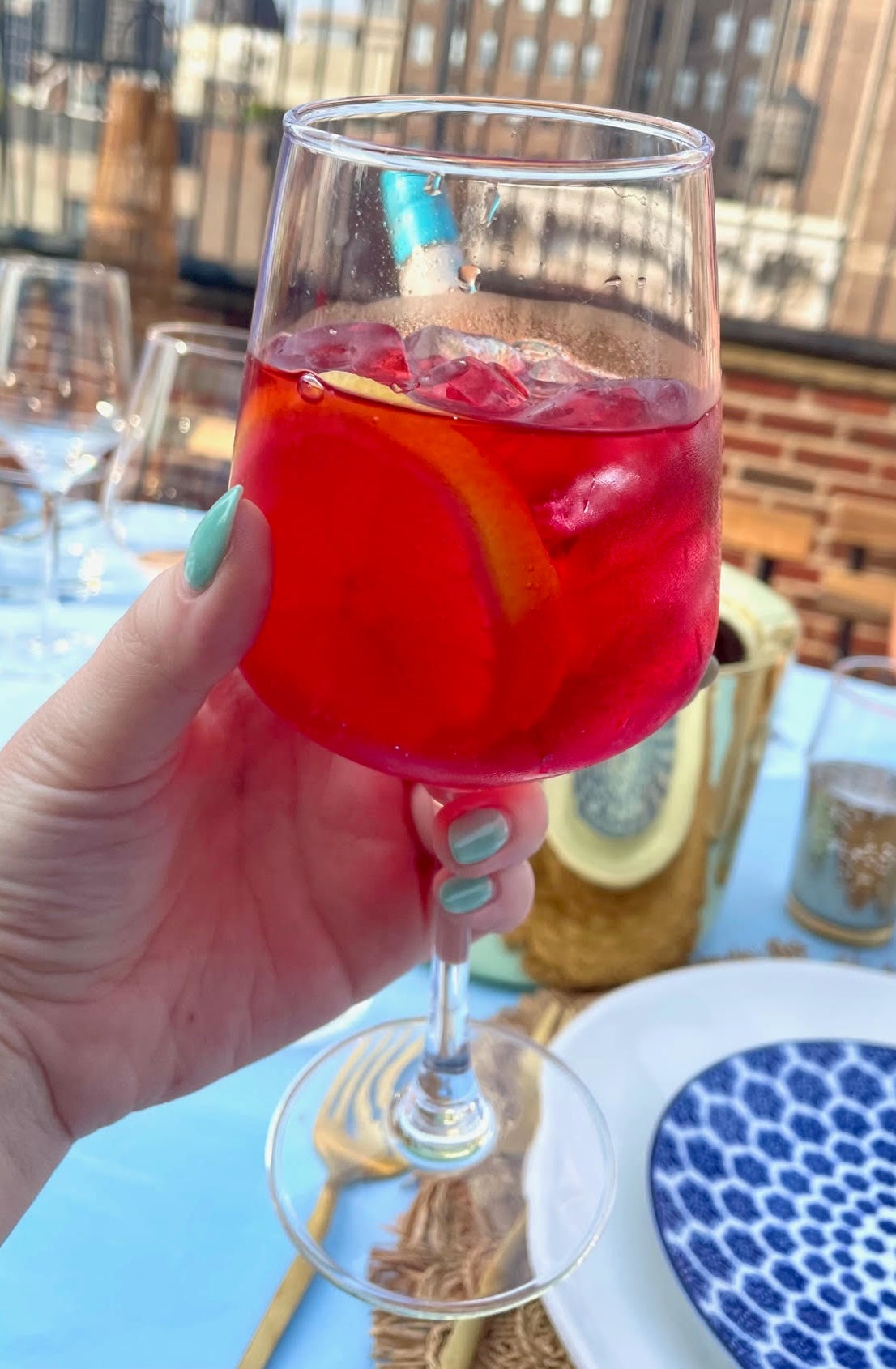 author holding an iced glass of the drink