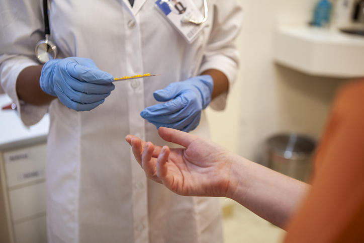 A patient&#x27;s hand reaching out to a nurse