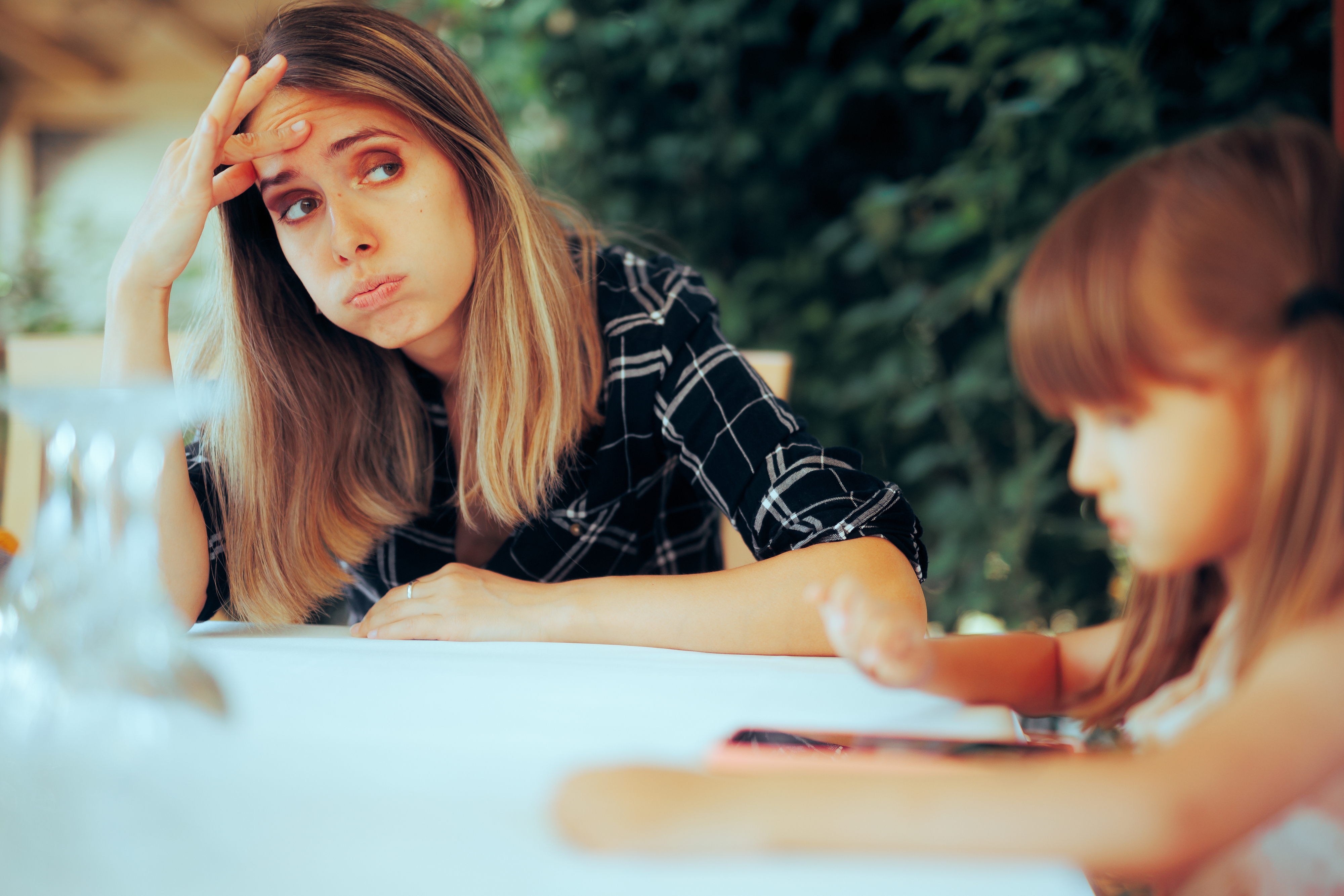 a woman sitting with a child and visibly stressed