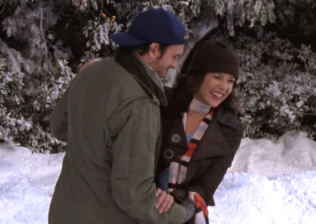 Luke smiles and he helps a laughing Lorelai up onto the slick, icy ground