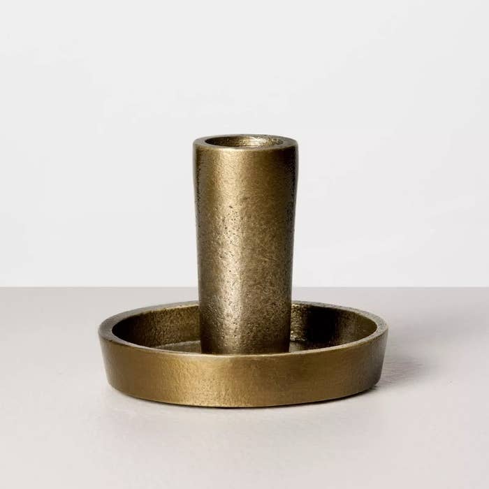 the golden candle holder with a matching base