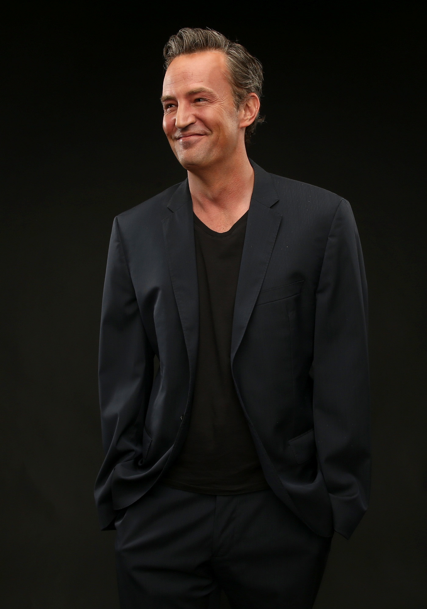 Close-up of Matthew in a suit and smiling