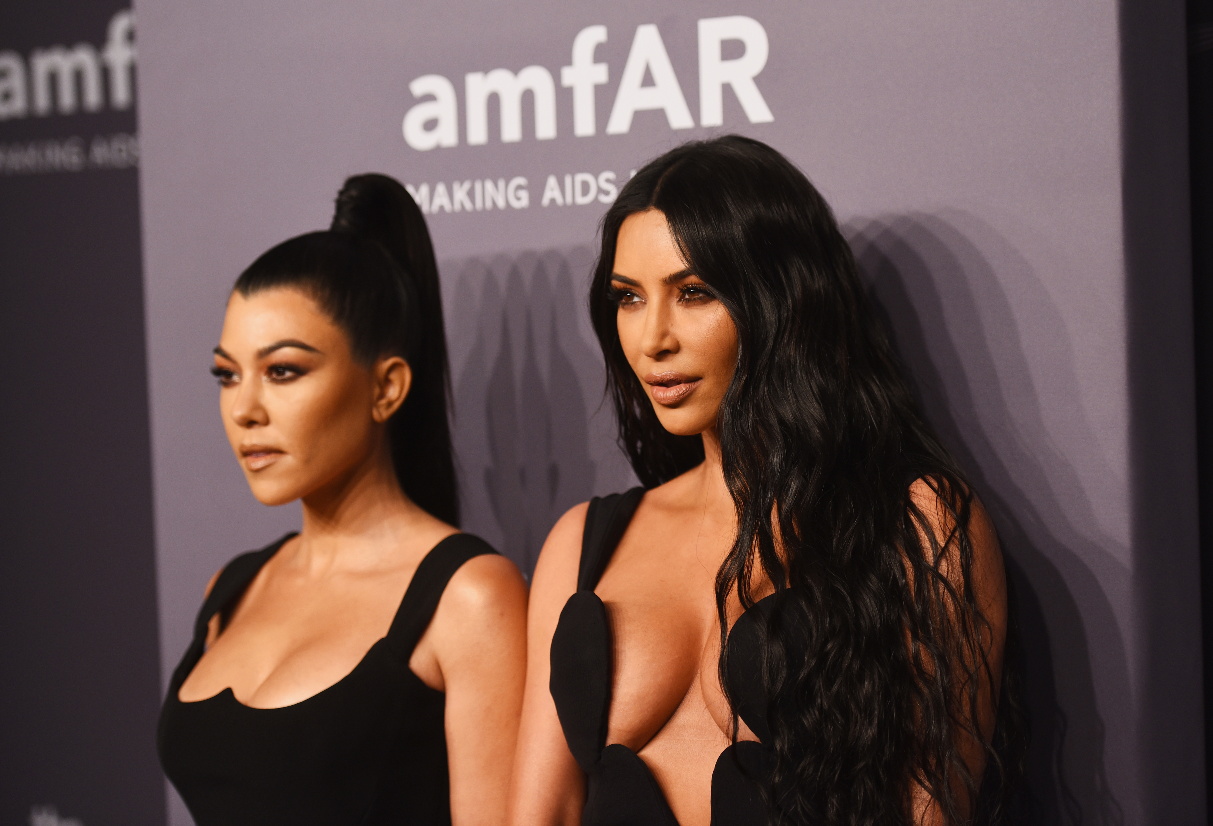 Close-up of Kim and Kourtney at a media event