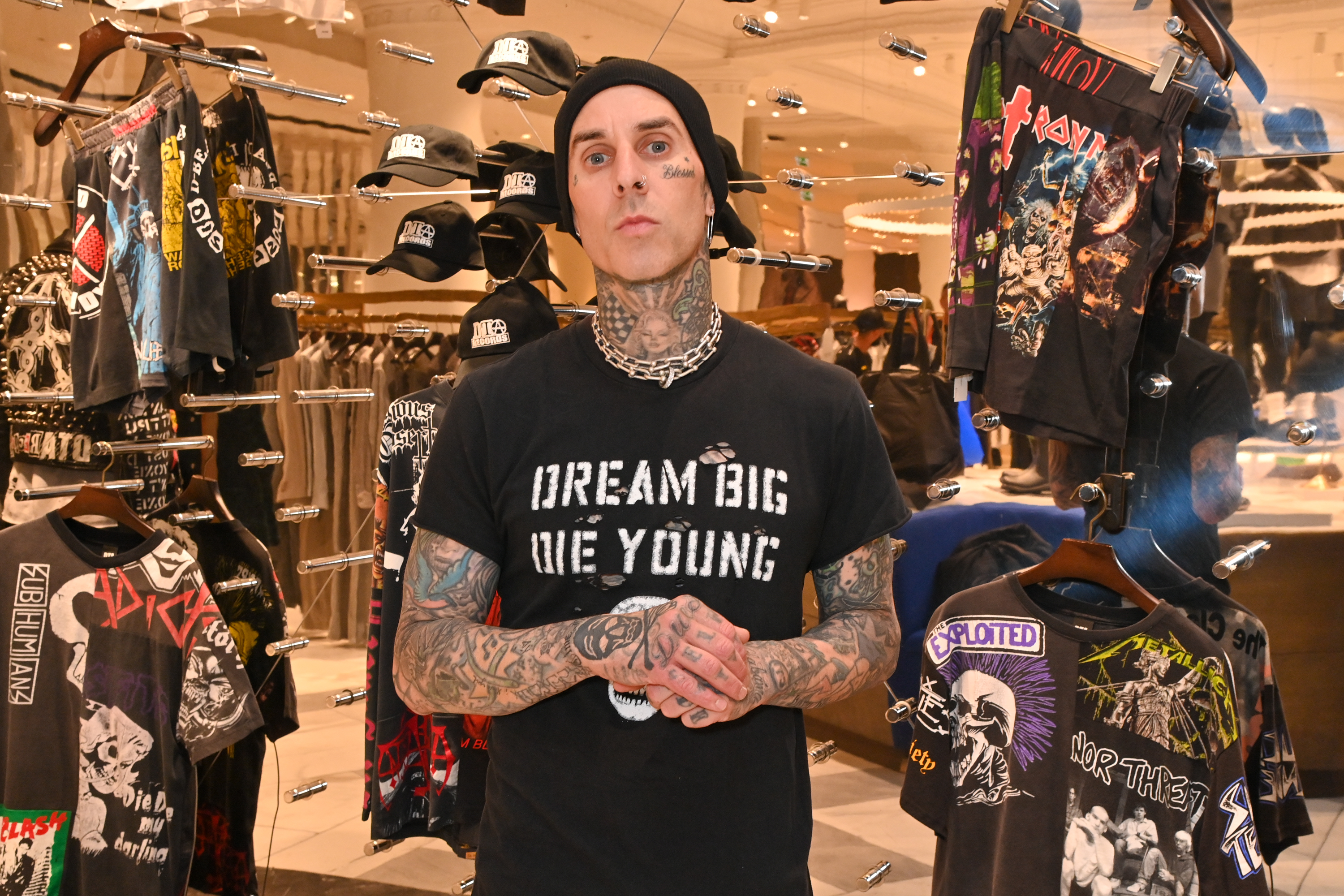 Close-up of Travis in a store wearing a &quot;Dream big die young&quot; T-shirt