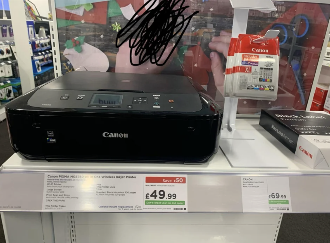 printer in a shop for $49.99 next to an ink cartridge that costs $69.99