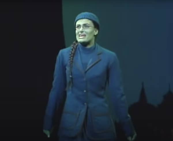 Idina as Elphaba onstage singing