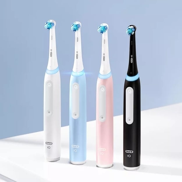 the toothbrush in white, blue, pink, and black