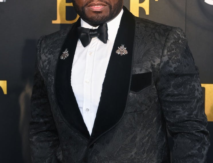 50 Cent in a suit and bowtie on the red carpet