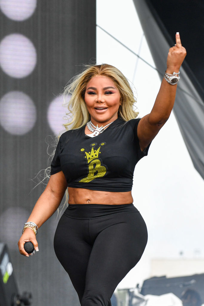 Lil Kim onstage giving the middle finger