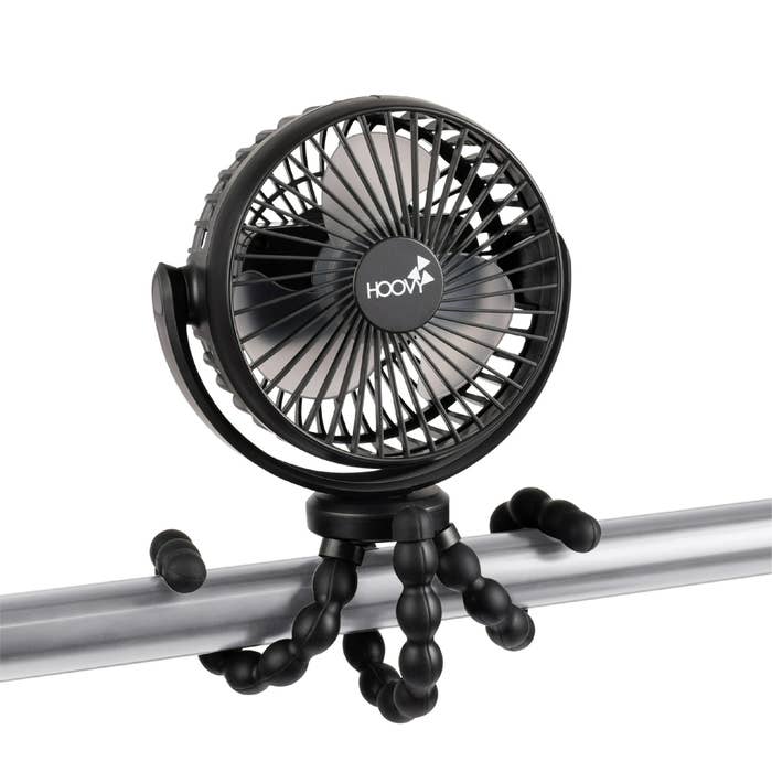 Portable fan with flexible tripod legs wrapped around a rod for stability. Perfect for personal cooling in various setups