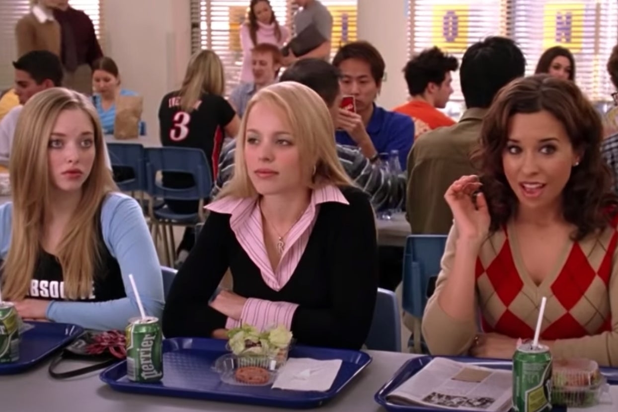 Karen, Regina, and Gretchen from Mean Girls sitting at a lunch table together