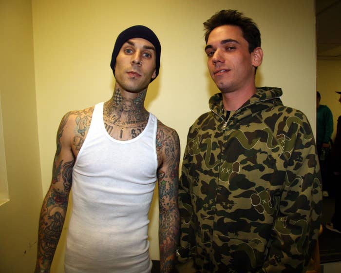 closeup of travis in a tank top and beanie and dj am in a hoodie