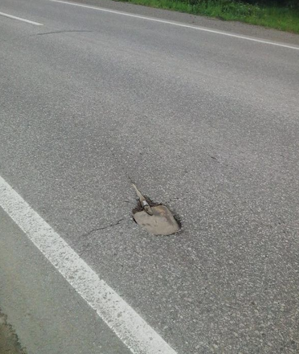 shovel stuck inside the road
