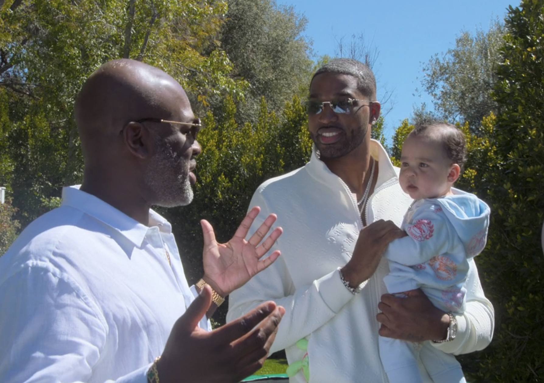 corey talking to tristan as tristan holding the baby