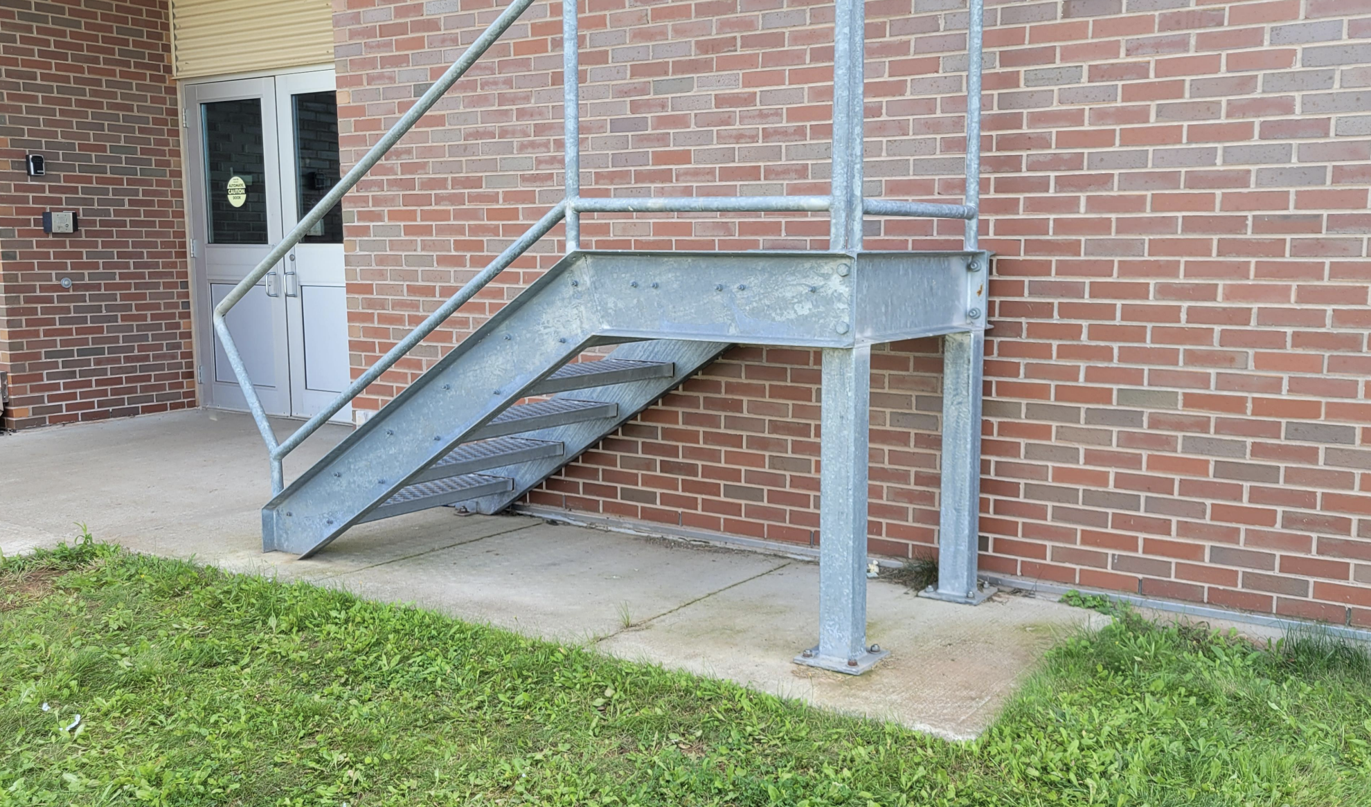 stairs leading to a platform that leads to a brick wall