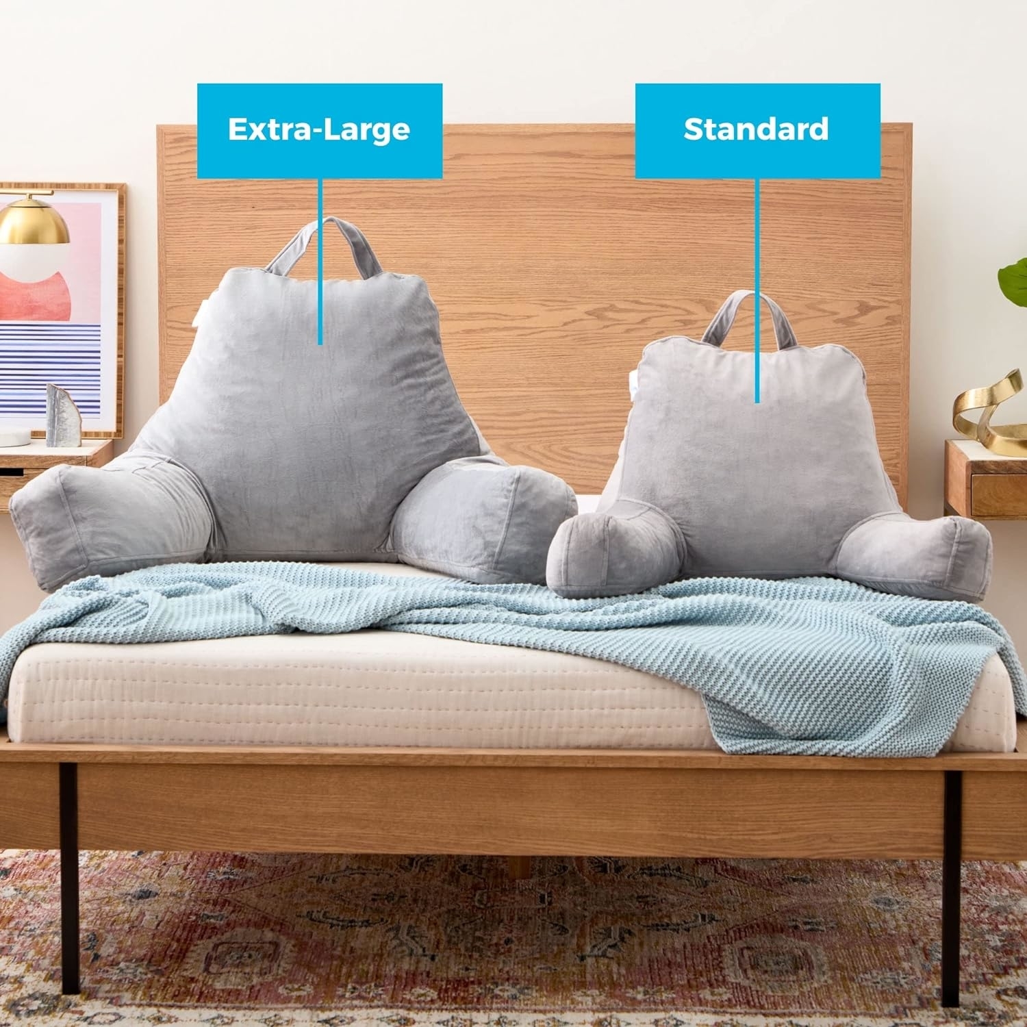 two gray pillows on a bed, one standard size and one extra large