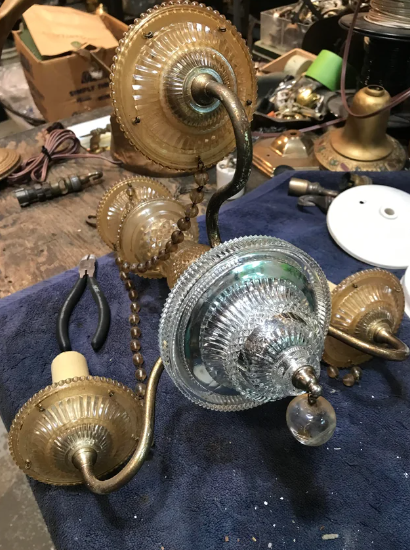 A chandelier mid-cleaning