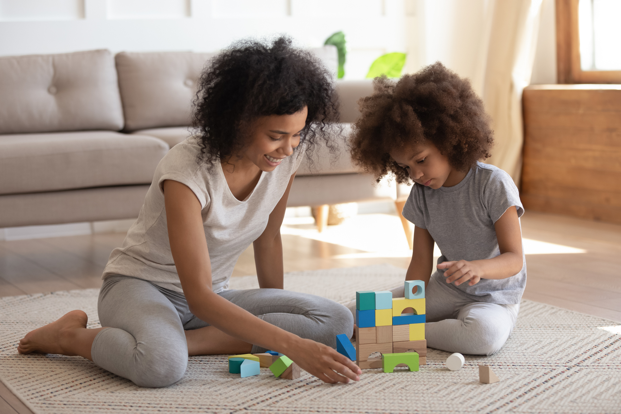 A mom and child playing with blocks