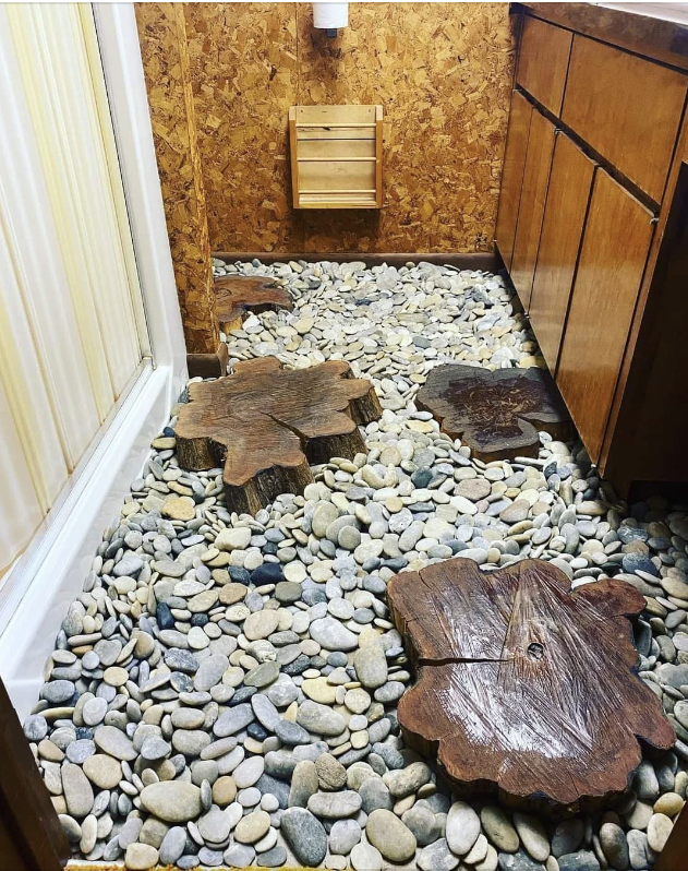 the floor of the bathroom is rocks