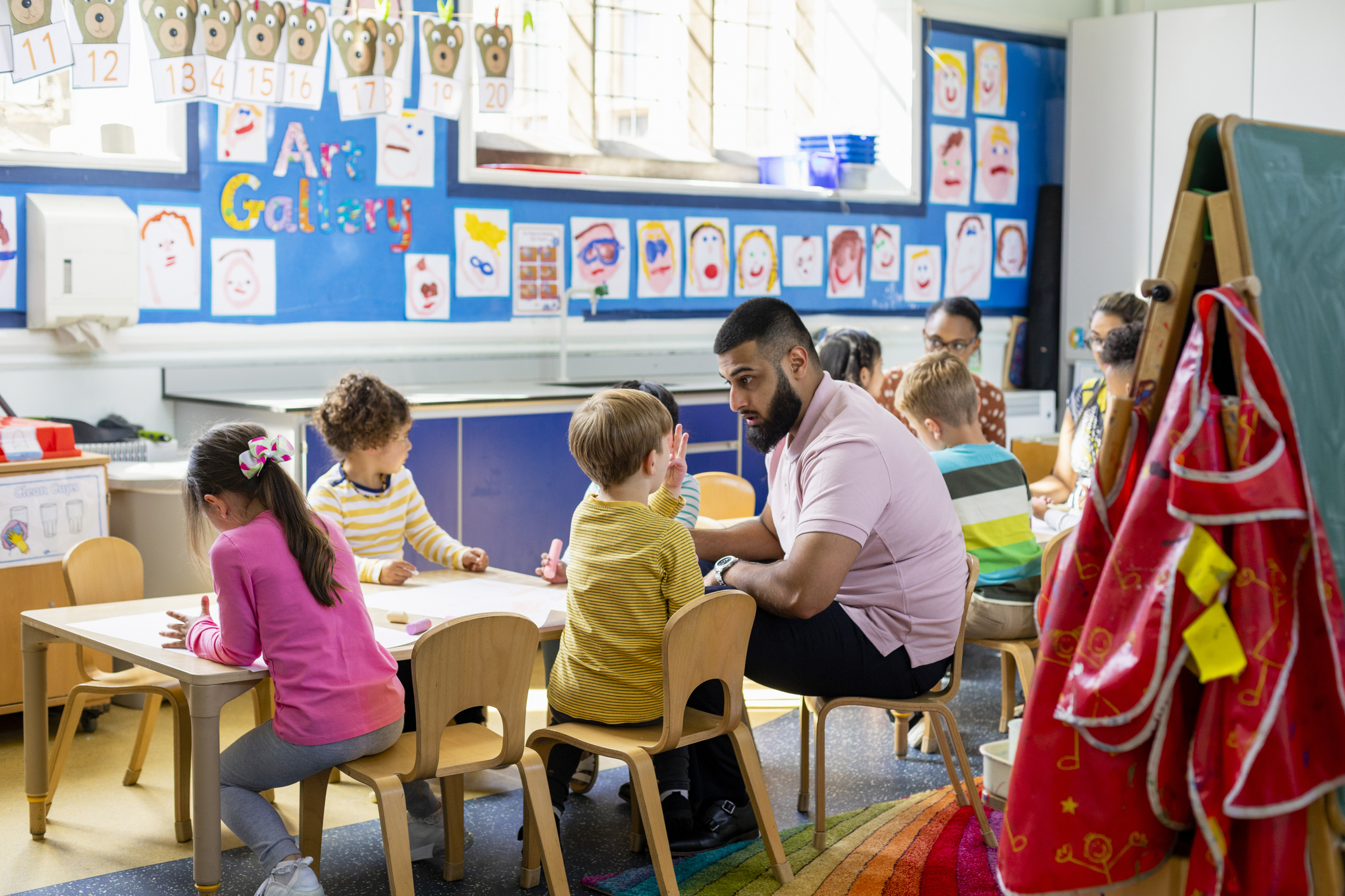 A man working with kids in a classroom