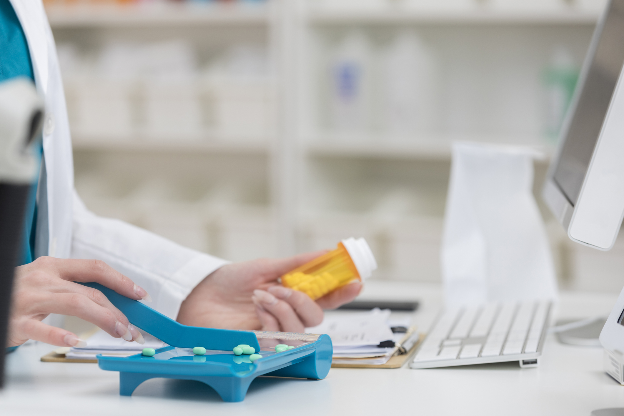 A pharmacist holding a pill bottle