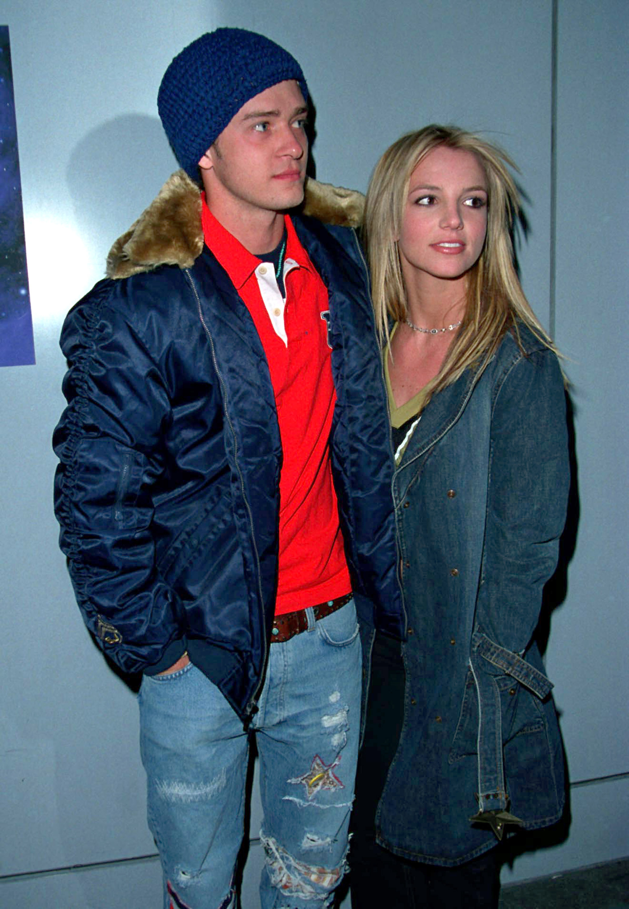 justin with his arm around britney while their bundled up in jackets