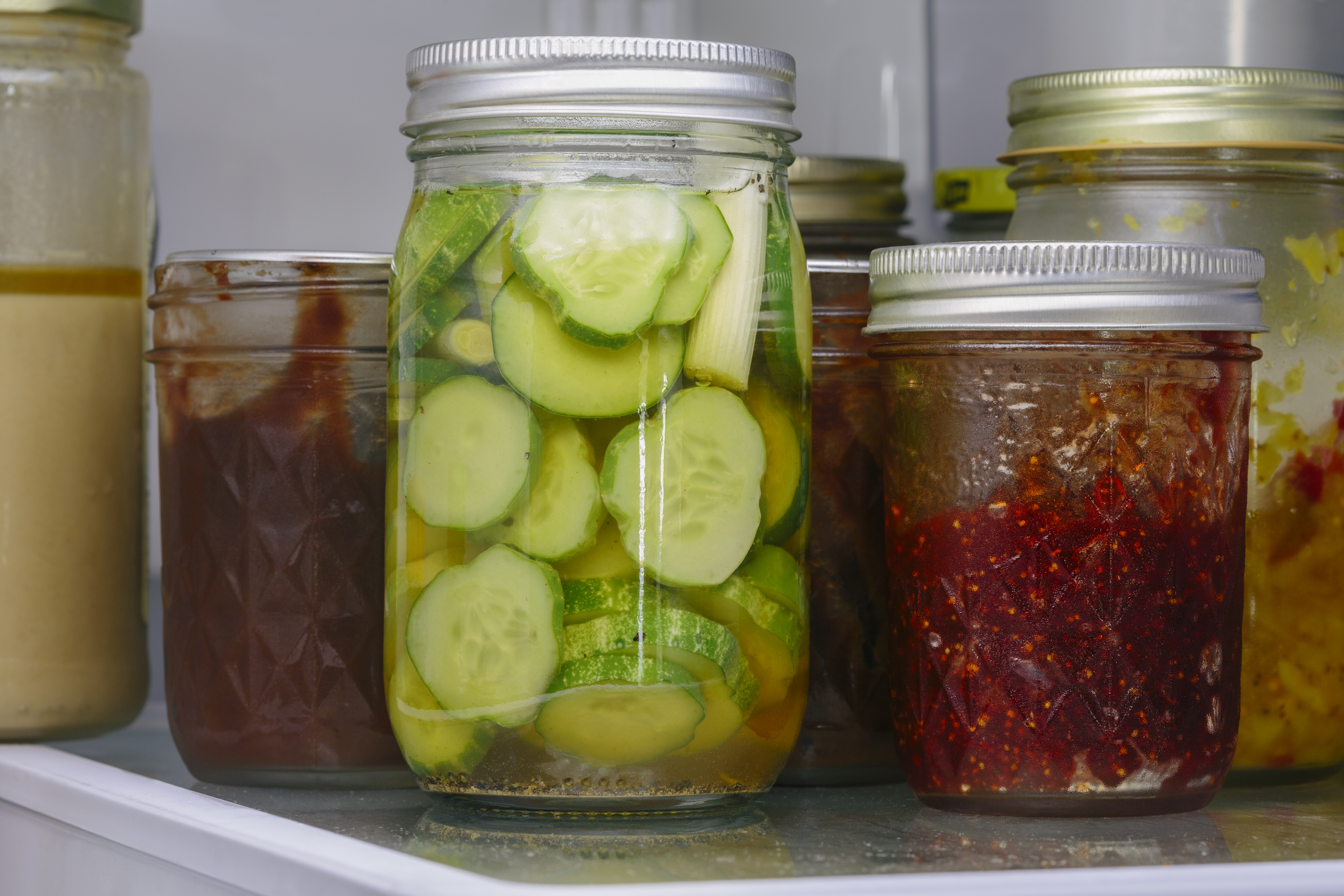 fridge stocked with glass jars of food