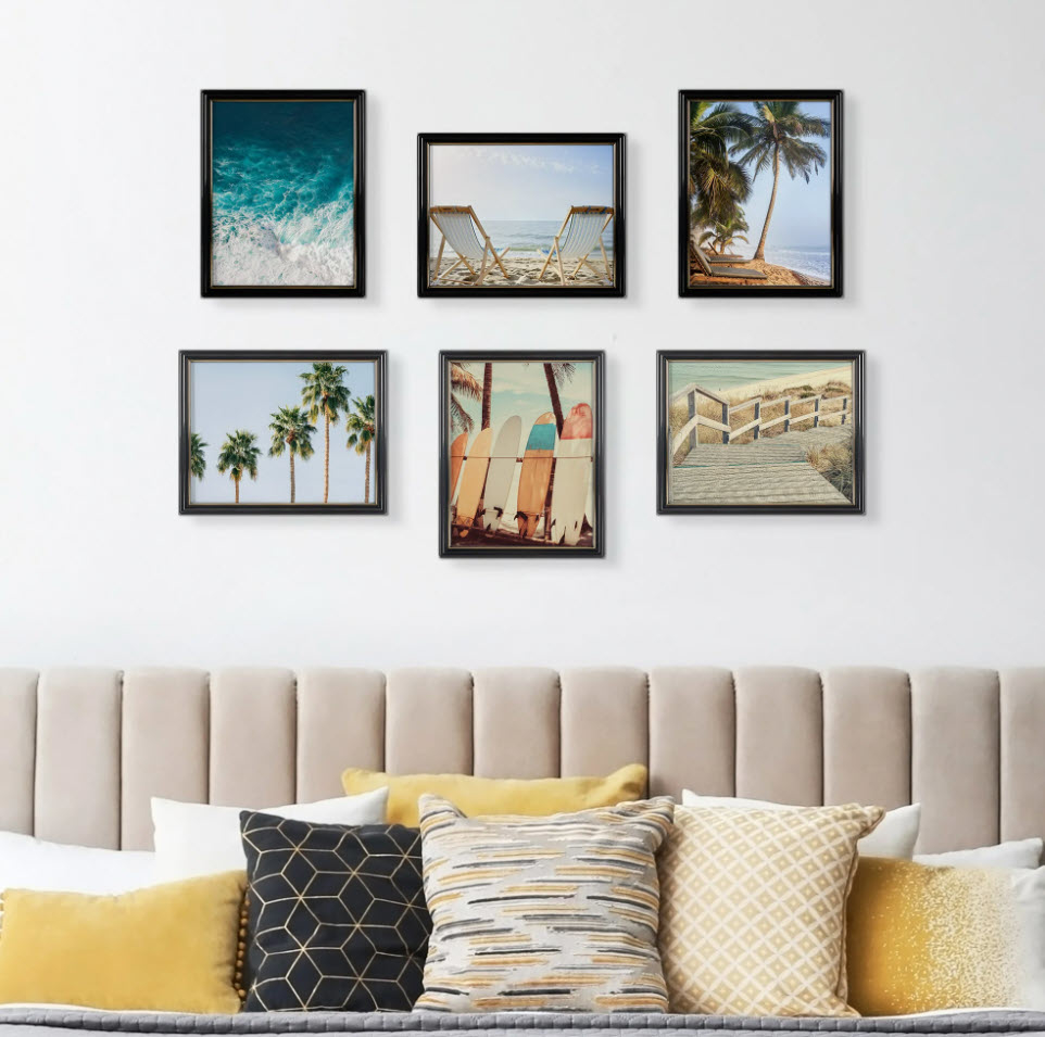 set of six wall hanging photo frames above bed