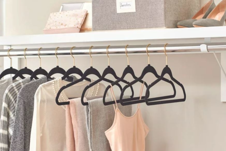 black velvet and gold hanger set of hangers in closet holding clothes