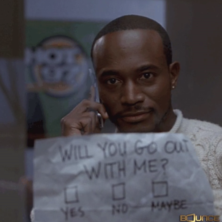 man holding a note that says will you go out with me