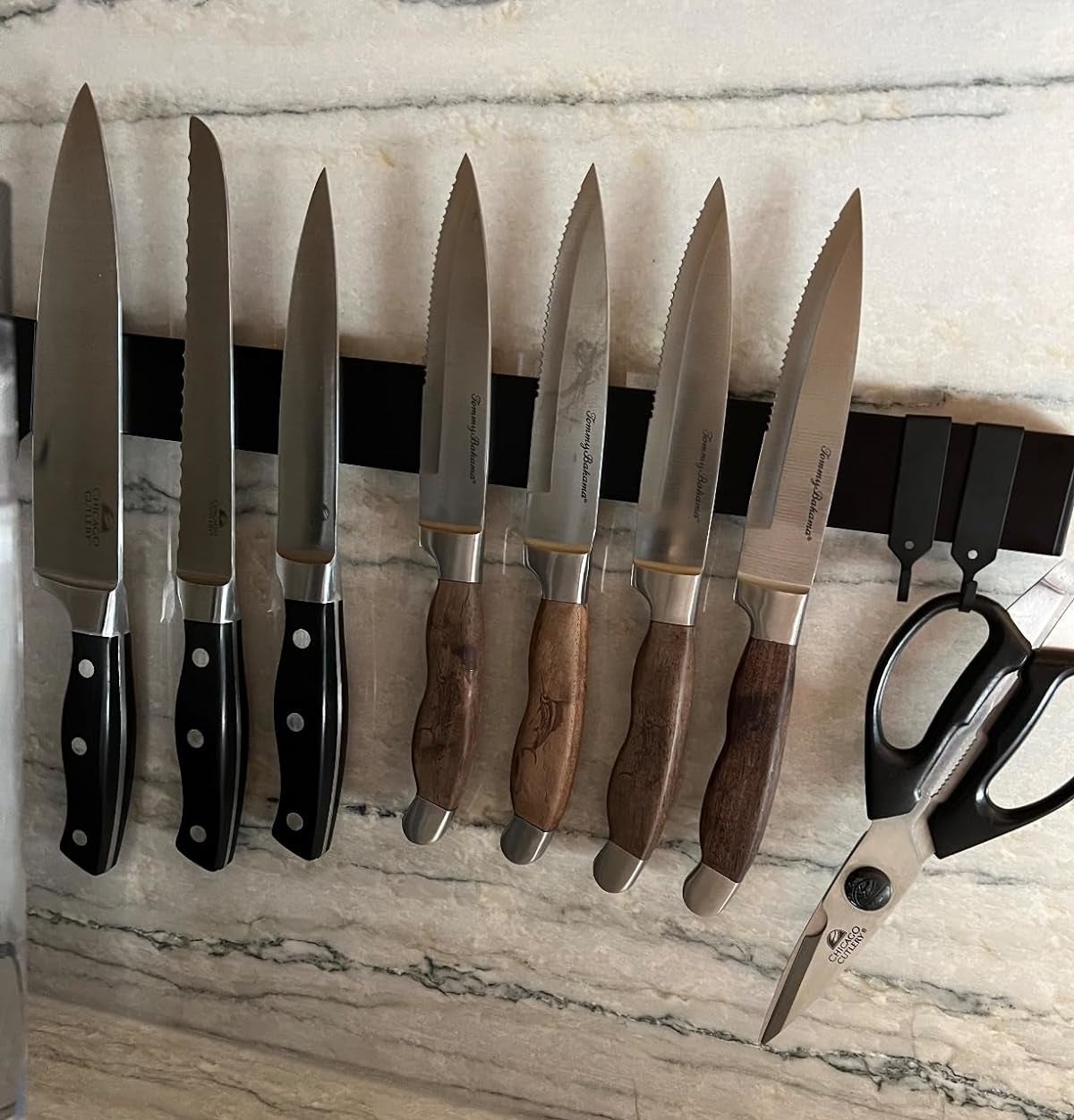 Reviewer image of the double-sided magnetic knife holder hanging in their kitchen