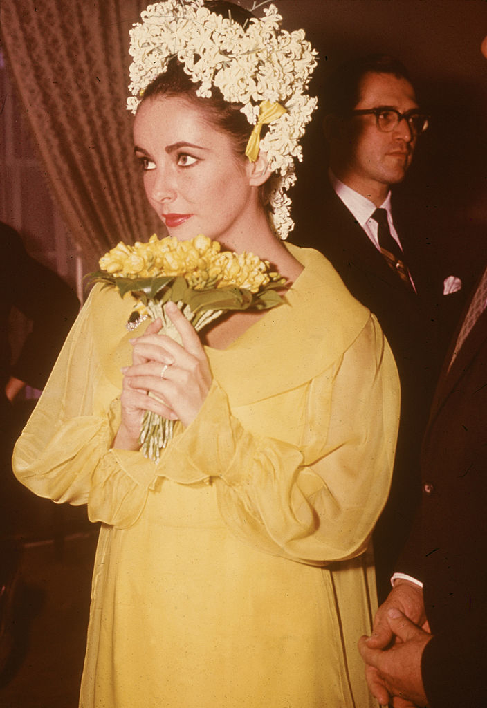 closeup of elizabeth holding her small bouquet to her face