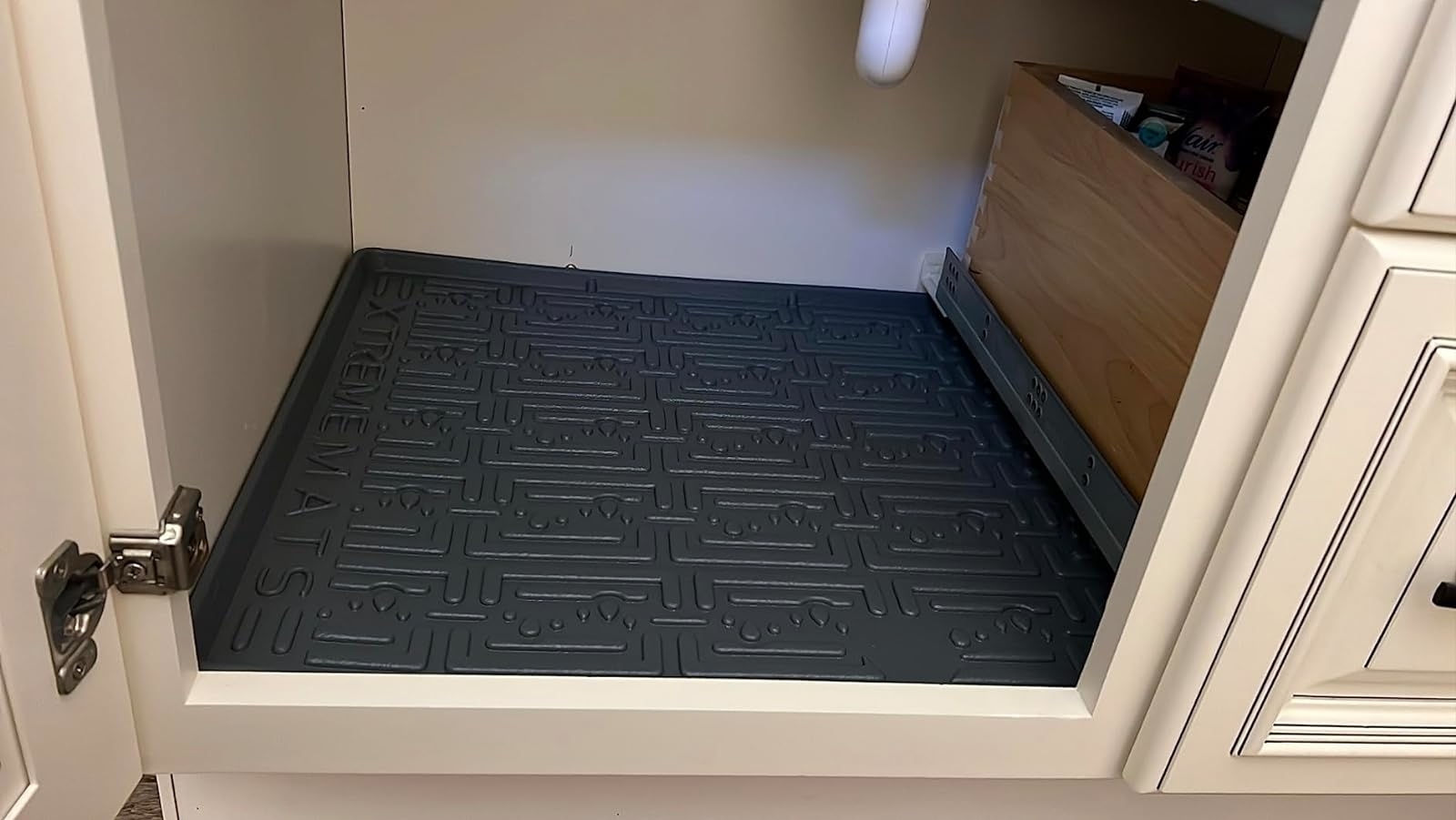 Reviewer image of the black mat lining the bottom of their cabinet