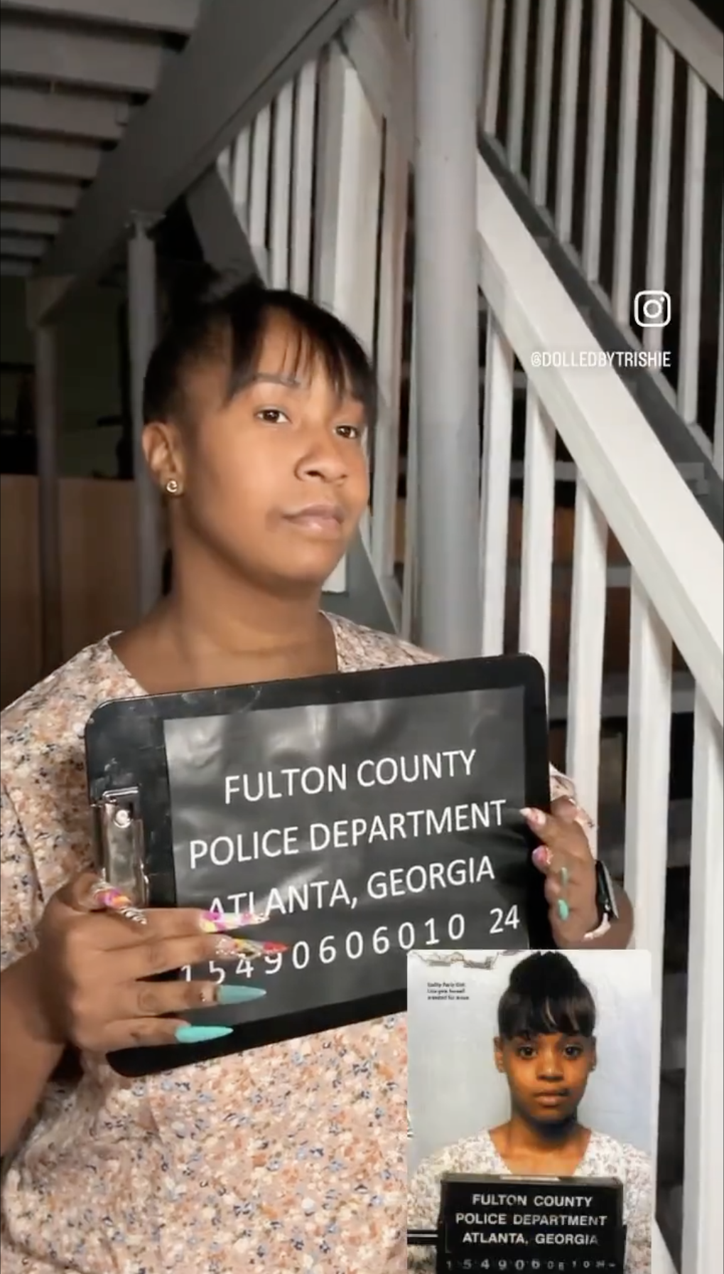 person holding up a board like a mug shot