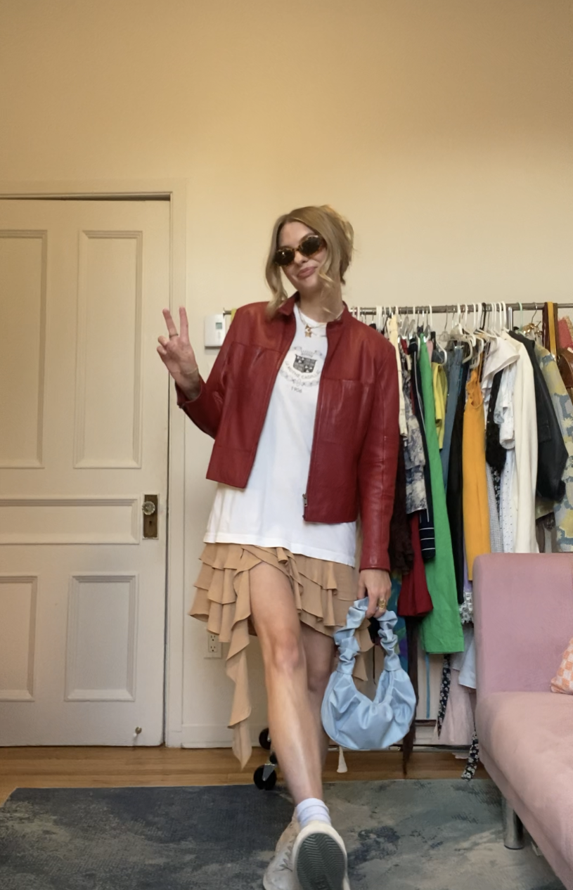 I am wearing the graphic tee again, the red leather jacket, sneakers, purse, sunglasses, and a ruffle dress underneath