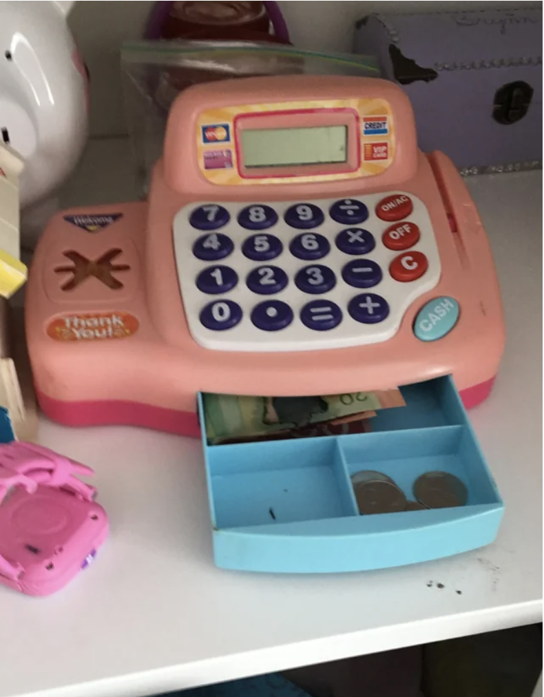 Toy cash register with real money in it