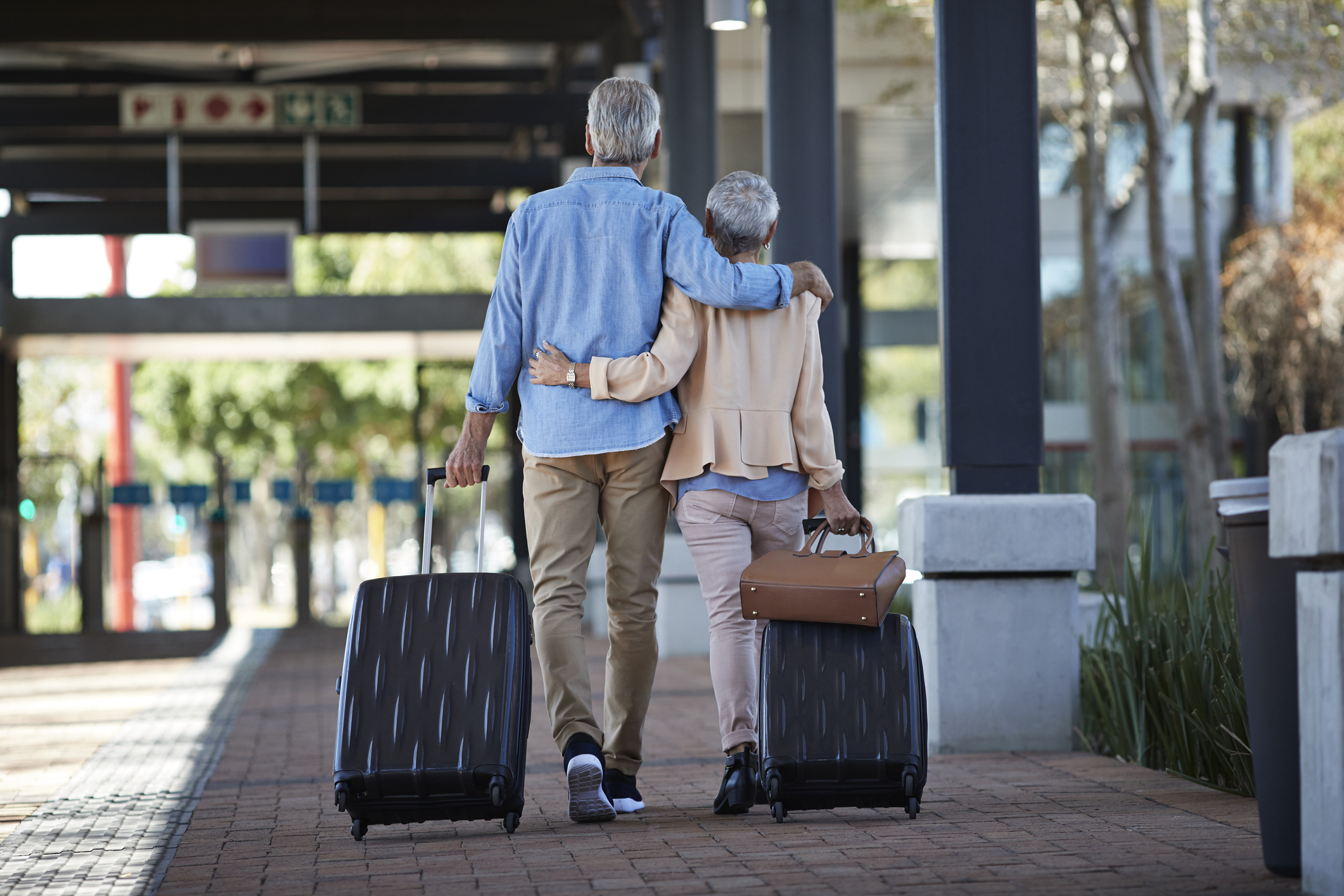 A couple walking with luggage