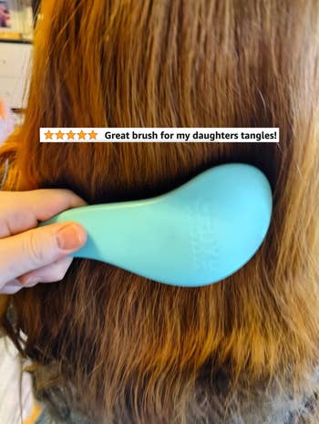 A reviewer brushing their kid's hair with text 