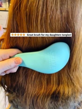 A reviewer brushing their kid's hair with text 