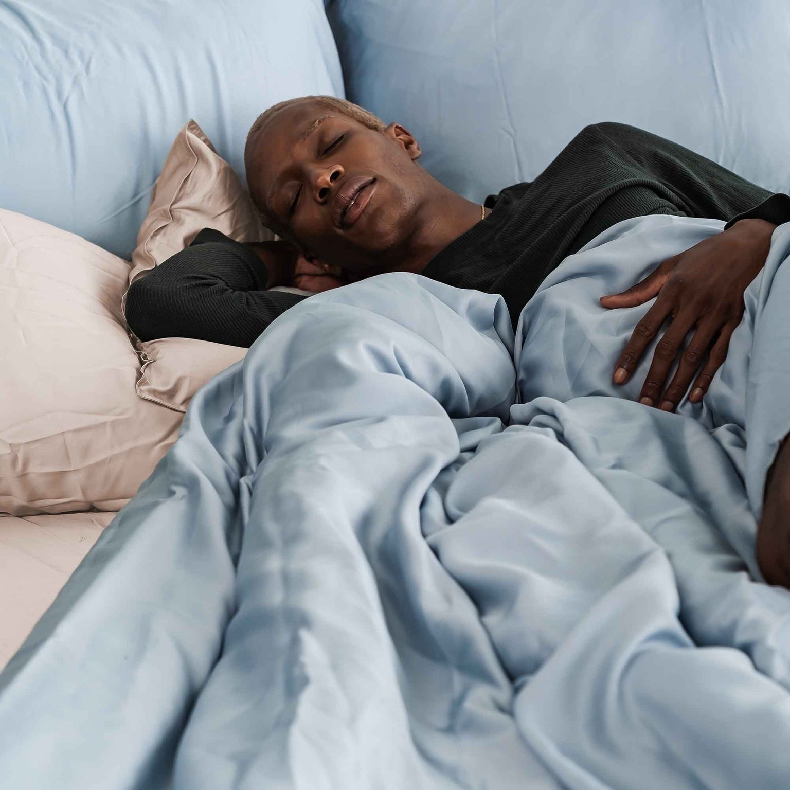 a model sleeping in the blue duvet