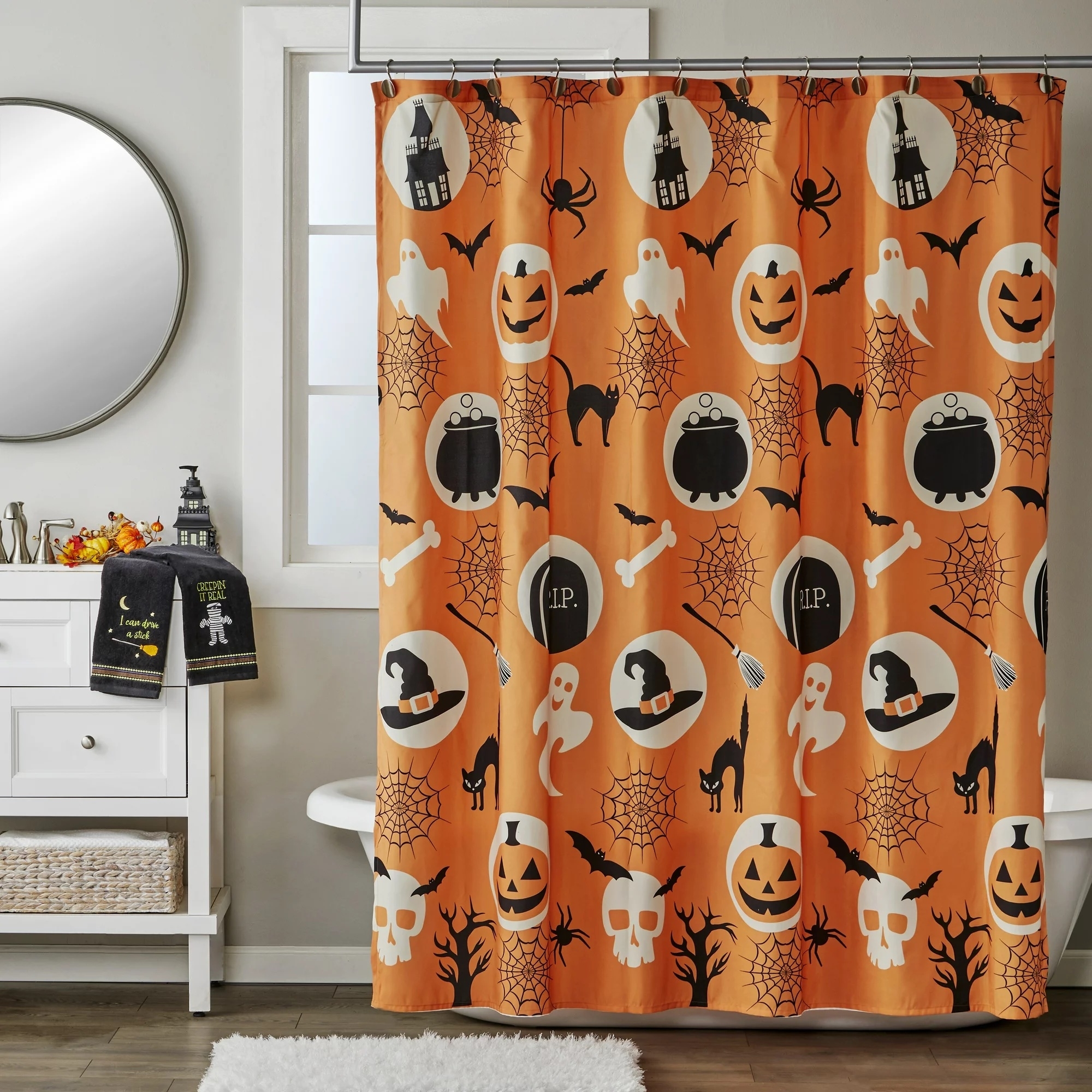 an orange shower curtain with halloween images on it