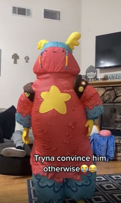 A kid in a costume with a ridged top, with the caption &quot;Tryna convince him otherwise&quot; and laughing emojis