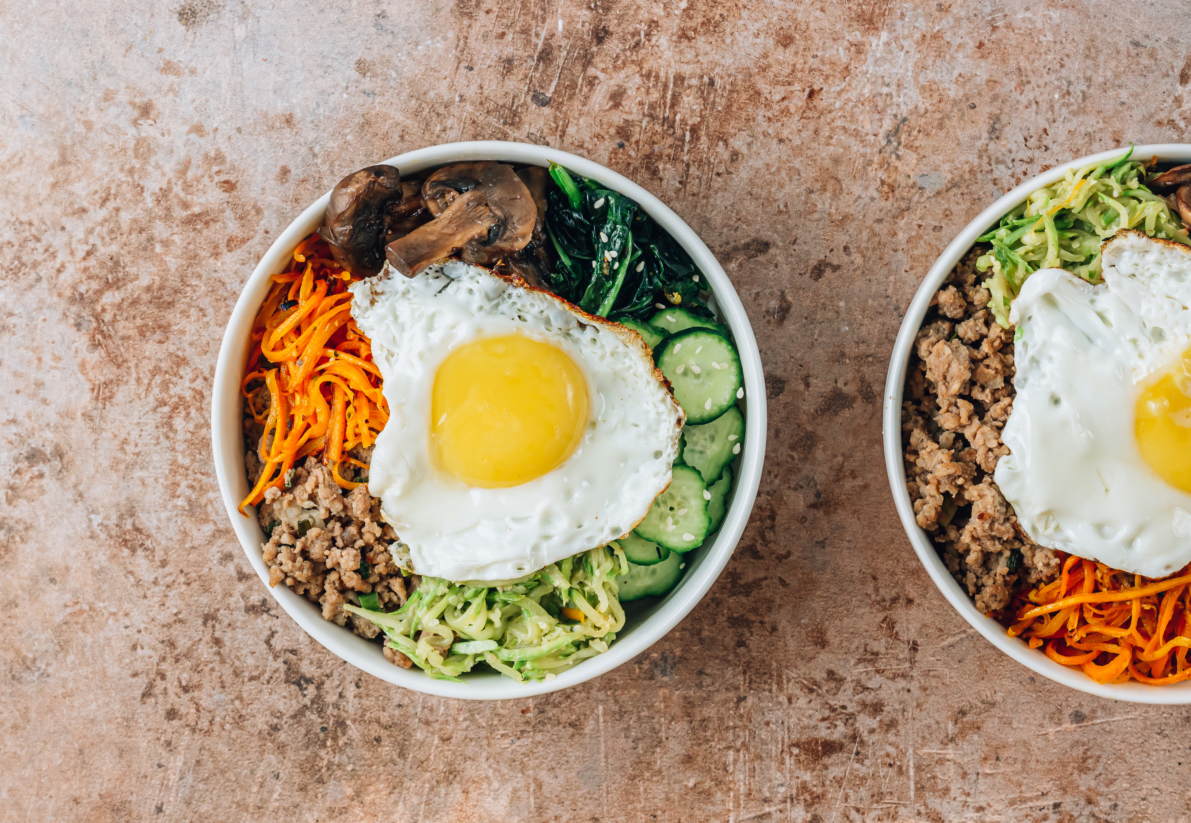 a bowl of bibimbap with a fried egg on tog