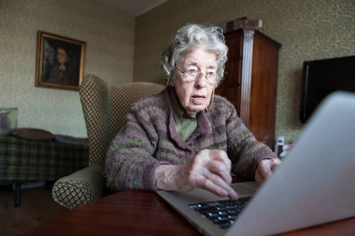 An old woman using a laptop